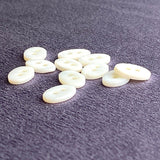 Re-Stocked White Oval Shell 2-Hole Tiny 1/2" Button.  Pack of TEN Buttons #LP-01